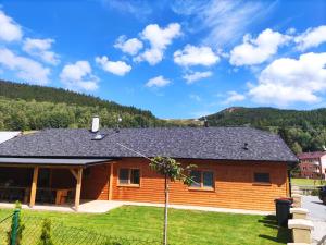 a log cabin with a roof at ChataTrucovna, wellnes in Lipova Lazne