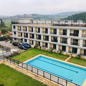 an apartment building with a swimming pool in front of it at Phoenix Apartment by LINK in Kigali