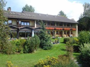 a large house with a garden in front of it at Pension Einsiedelei in Zwiesel