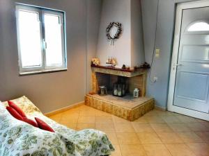 a room with a fireplace and a bed and a door at Kamares View in Ayeranós