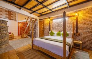 a bedroom with a bed and a brick wall at THE CEDAR CASTLE in Mukteswar