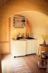 een keuken met witte kasten en een wastafel bij Tiny House Kotten Kunterbunt in Nottuln