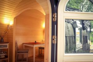 een gewelfde deur naar een sauna met een tafel bij Tiny House Kotten Kunterbunt in Nottuln