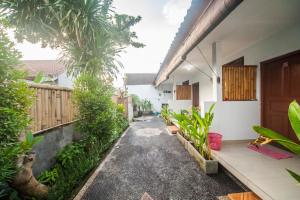 a courtyard of a house with trees and a walkway at The Tegal Canggu in Canggu