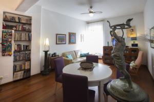 a living room with a table with a statue on it at Living in San Peter in Rome