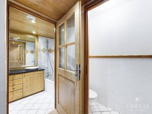 a bathroom with a shower and a toilet and a door at Appartement Montvalezan-La Rosière, 2 pièces, 4 personnes - FR-1-398-520 in La Rosière