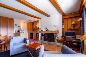a living room with a couch and a fireplace at Senator 129 in Verbier