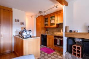 a kitchen with wooden cabinets and a counter top at Senator 129 in Verbier +3 photos