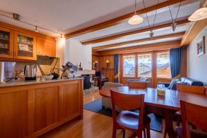 a kitchen and dining room with a table and chairs at Senator 129 in Verbier