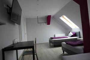 a living room with a bed and a table and a couch at Pension Sölde UG in Dortmund