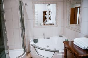 a white bathroom with a tub and a shower at Apartamenty Gala in Sułkowice +26 photos