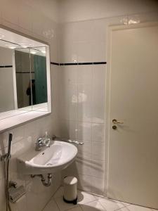 a bathroom with a sink and a shower with a mirror at Traumhafte Wohnung im Herzen von Leipzig in Leipzig