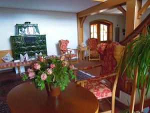 ein Wohnzimmer mit einem Tisch und einer Blumenvase in der Unterkunft Hotel Rappensberg garni in Bad Birnbach