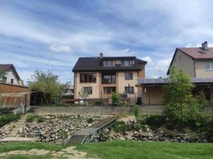 a house with a rock garden in front of a house at Dom pri potoku in Zuberec