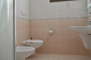 a bathroom with a toilet and a sink at Hotel Marco Effe in Mestrino +29 photos