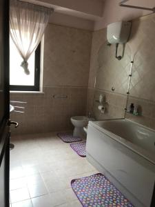 a bathroom with a tub and a toilet at Casa Di Marzio in Pratola Peligna