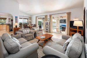 a large living room with couches and a table at Casa Madrugada in Carvoeiro