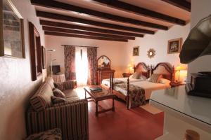 sypialnia z łóżkiem, kanapą i krzesłami w obiekcie Petit Hotel Ses Rotges - Only Adults w Cala Ratjada