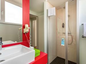 a bathroom with a sink and a shower at ibis Styles Karlsruhe Ettlingen in Ettlingen