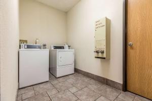 a room with two refrigerators and a sign on the wall at Motel 6-Indianapolis, IN - Southport in Indianapolis