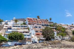 a large apartment building on top of a hill at Ocean and Siam Park view Home by LoveTenerife in Adeje