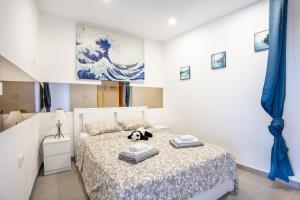 a bedroom with a bed with a stuffed animal on it at Ocean and Siam Park view Home by LoveTenerife in Adeje