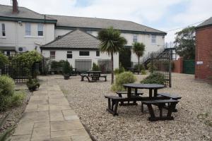 a picnic table and benches in a courtyard at Wortley House Hotel in Scunthorpe