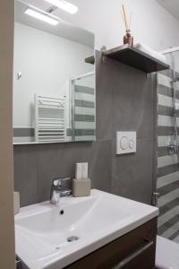a bathroom with a white sink and a mirror at Amore Se Luxury Apartment in Corato