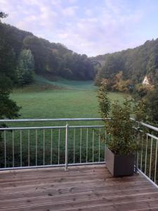 a balcony with a view of a field and a river at Zur Mühle in Mörlenbach
