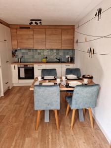 uma cozinha com uma mesa de madeira e 2 cadeiras em Gemütliche Ferienwohnung zwischen See und Bergen em Brienz