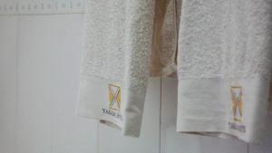 three towels hanging on a wall in a bathroom at Yakam Hotel Limited in Kintampo