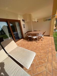a patio with a table and a bench and a table at La Marea in Chia