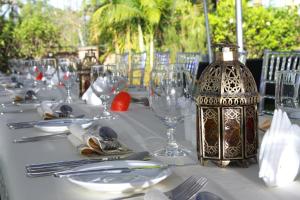 a table with glasses and a bottle on top of it at The Bedelle in Nairobi