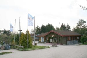 a building with two flags in front of it at Ferienpark Lauterdörfle 9 in Hayingen +12 photos