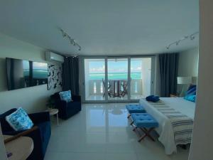a bedroom with a bed and a living room at KASA Terrace Studio Breathtaking Ocean Views in San Juan