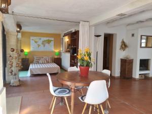 a living room with a table and chairs and a bed at Charming stone villa with pool & garden in Montaren-et-Saint-Médiers