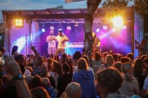 a group of people on a stage in front of a crowd at Surfviken in Stenungsund