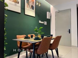 a dining room with a table and chairs at 2BR2B Hozem KL1807 Apartment Kepong in Kuala Lumpur