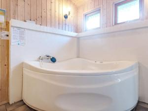 a bathroom with a toilet and a bath tub at 8 person holiday home in Roslev in Glyngøre