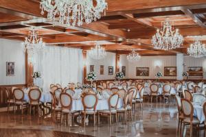a banquet hall with tables and chairs and chandeliers at Apartamenty Gala in Sułkowice