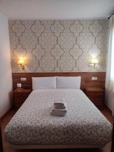 a bedroom with a bed with two towels on it at Salomé in Madrid