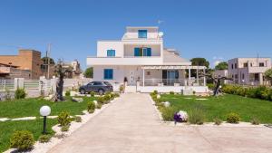 a white house with a driveway in front of it at Villa Patrizia Selinunte in Marinella di Selinunte