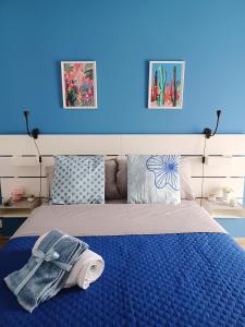 een blauwe slaapkamer met een bed met een blauwe muur bij Joy Home 31 in Milaan