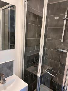 a bathroom with a shower and a sink at The Serviced Accommodations in Harlow