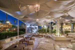 a large room with couches and tables under a tent at Sindbad Club in Hurghada