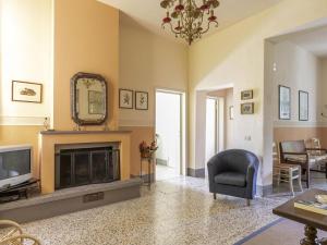 a living room with a fireplace and a mirror at Holiday Home Tuscany with Pool Access in Marti