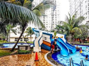 a water park with a slide in a pool at Capital O 91820 S&a Collection 2 in Jakarta