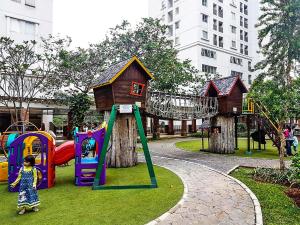 a park with a playground with a house and slides at Capital O 91820 S&a Collection 2 in Jakarta