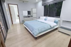 a bedroom with a bed and a large window at Lovely modern 2 bed villa in Pran Buri +26 photos