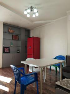 a kitchen with a table and chairs and a red refrigerator at AURA on Gogol street 28a in Bishkek